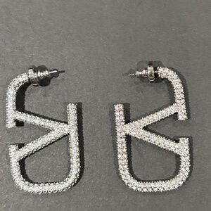 Gorgeous Valentino Signature V silver earring embedded with Swarovski Crystals
